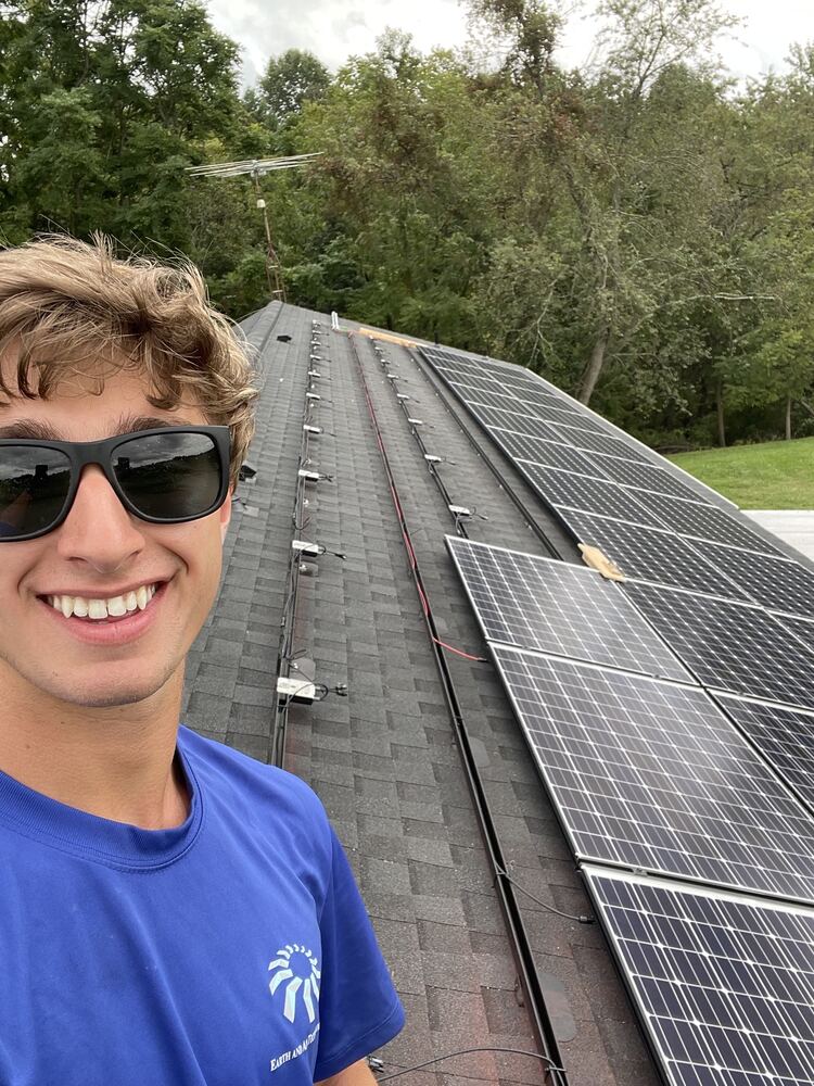 Pearce working on a solar panel installation, before he wrote code